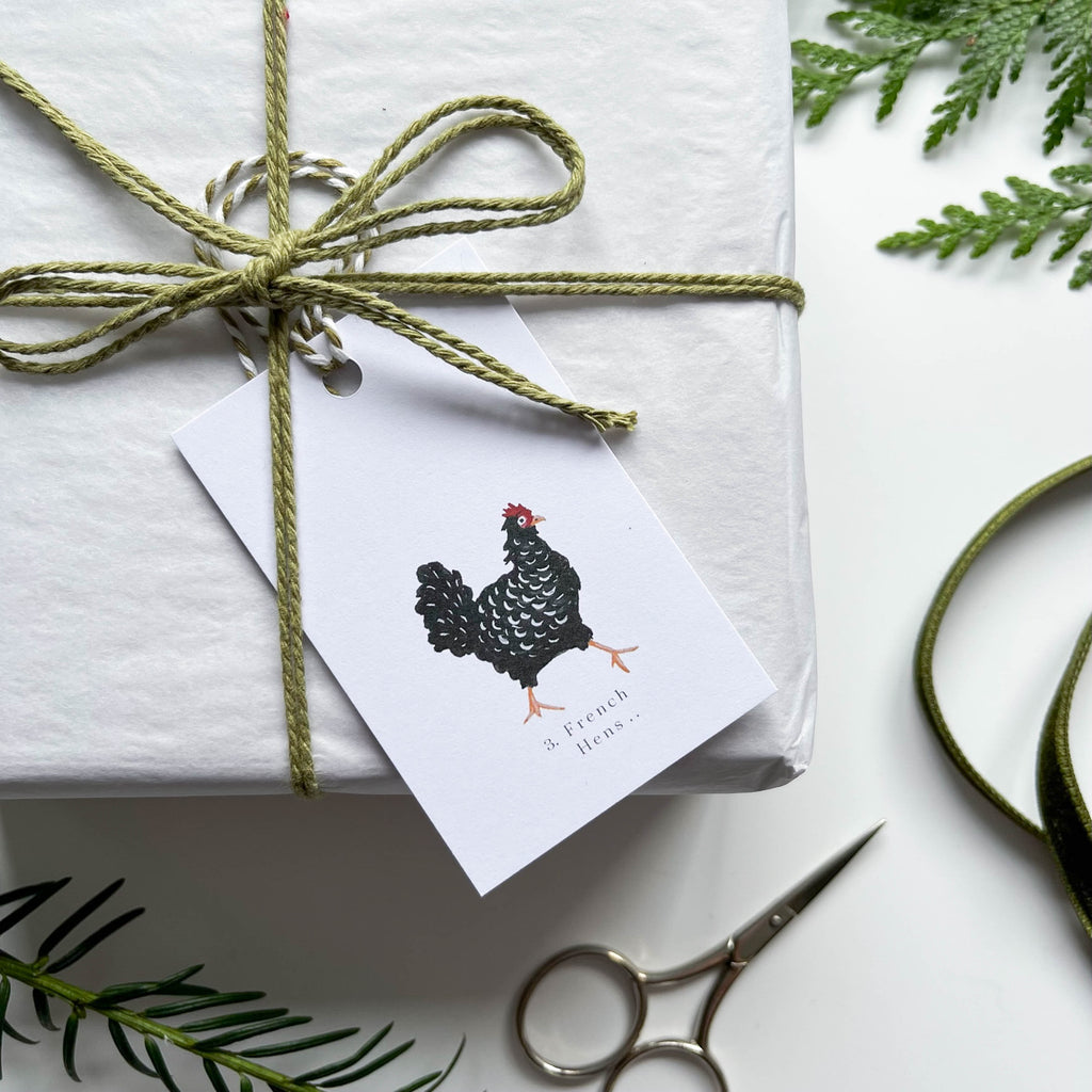 12 days of christmas hand illustrated 3 french hens gift tage on box with string & winter foliage