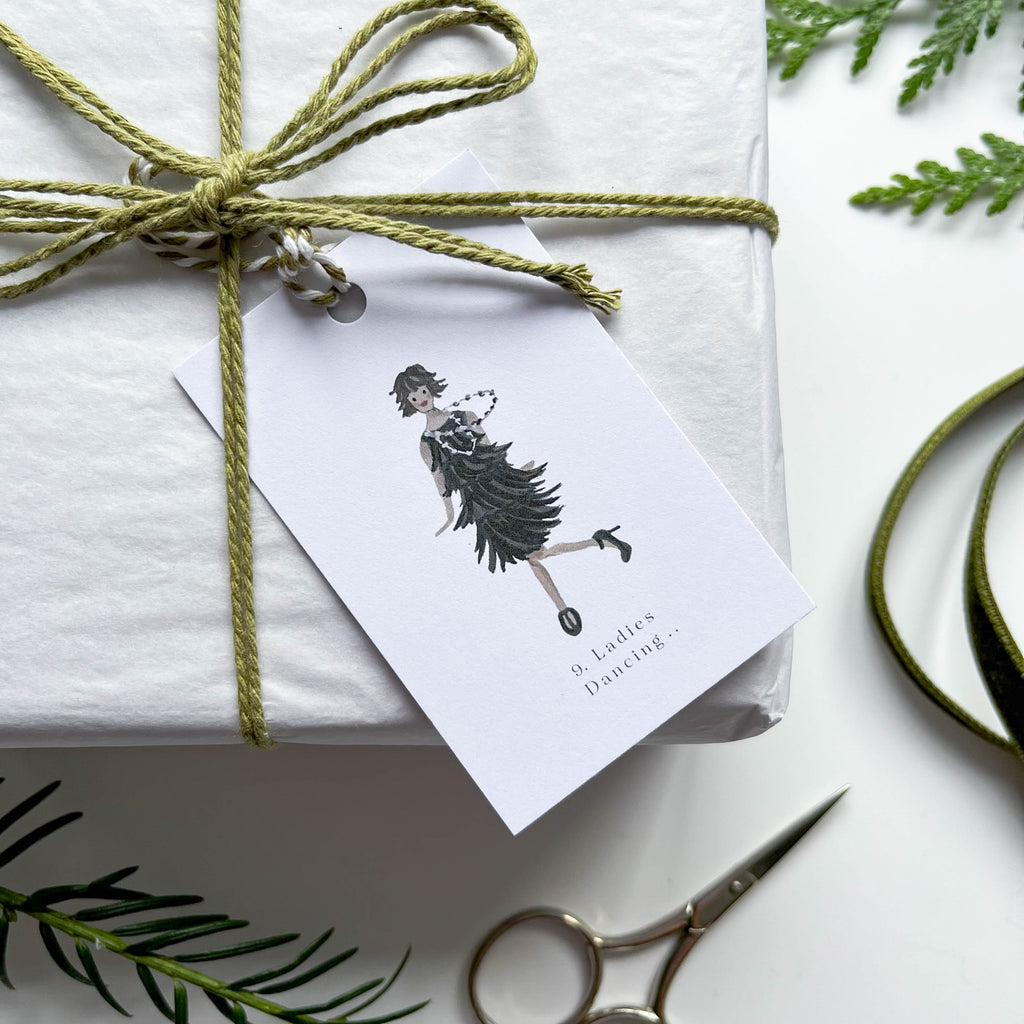 9 ladies dancing gift tag hand illustrated 12 days of christmas gift tag on box with green string 