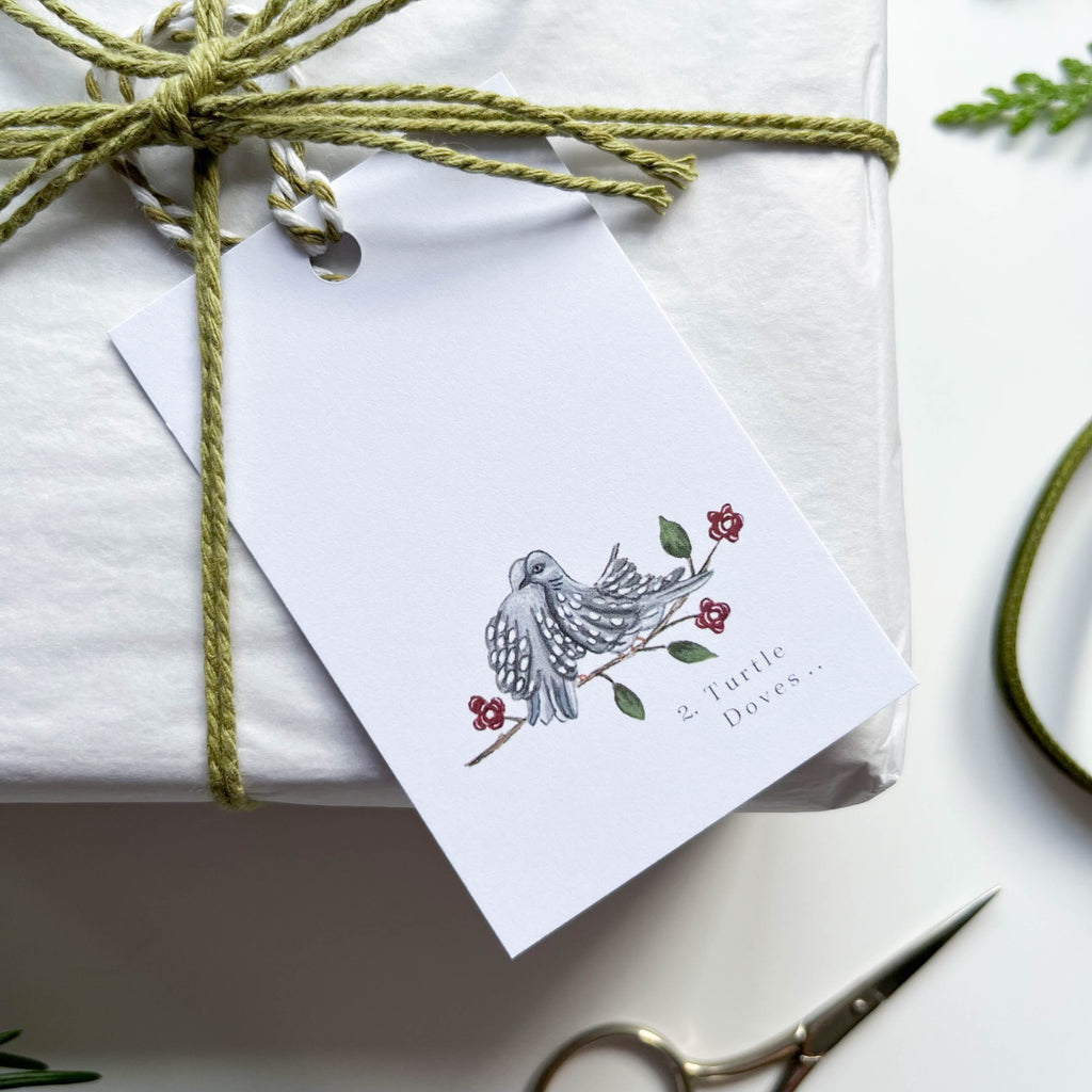 2 turtle doves on branch gift tag hand illustrated 12 days of christmas gift tag on box with green string